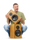 Man with two wooden speaker on white