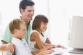 Man and two young children with computer Royalty Free Stock Photo