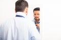 Man tying a necktie in front of mirror Royalty Free Stock Photo