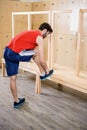 Man tying shoelace in locker room Royalty Free Stock Photo