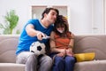 The man tying up his wife to watch sports football Royalty Free Stock Photo