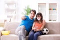 The man tying up his wife to watch sports football Royalty Free Stock Photo