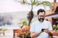 Man type on a modern cellular phone device in outdoor leisure activity with technology - portrait of aged adult with defocused Royalty Free Stock Photo