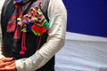 Man in a typical nepali rai dress with decorative items on the coat