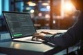 Man Typing Code At A Laptop In An Office At Sunset