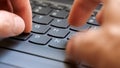 Man typing fast on a new gray modern laptop keyboard, closeup, real time, one person. Creative content writing, quickly typing