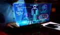 Man typing on keyboard with game creating on hologram screen