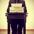 Man typing and old typewriter, with a retro effect Royalty Free Stock Photo