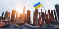 Man with Ukraine flag on city ruin. Ukrainian victory