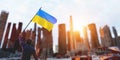 Man with Ukraine flag on city ruin. Ukrainian victory