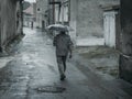 Man with umbrella on rainy day in town Royalty Free Stock Photo