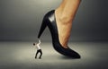 Man under big female heel Royalty Free Stock Photo