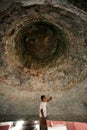 Man under a Mingun bell in Myanmar. Royalty Free Stock Photo