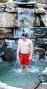 Man under Nordic Cold Water Spa Cascade Royalty Free Stock Photo