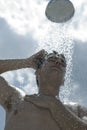 Man under outdoor shower Royalty Free Stock Photo