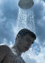 Man under outdoor shower Royalty Free Stock Photo