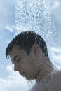 Man under outdoor shower Royalty Free Stock Photo