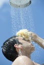 Man under outdoor shower Royalty Free Stock Photo