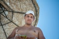 The man under a solar umbrella on beach Royalty Free Stock Photo