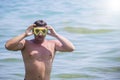 Man with an underwater mask is engaged in diving.A man in a mask floats in salt water.