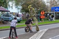 Street entertainment. Unicyclists and a stilt walker