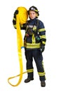 Man in uniform of firefighter holds hardhat and fire hose Royalty Free Stock Photo