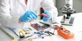 A man in uniform with voltmeter and a red battery in his hands Royalty Free Stock Photo