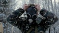 Man in uniform wearing a gas mask in the winter forest. portrait of a young soldier wearing a gas mask against a nature Royalty Free Stock Photo