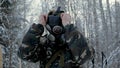 Man in uniform wearing a gas mask in the winter forest. portrait of a young soldier wearing a gas mask against a nature Royalty Free Stock Photo