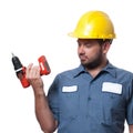 Man in uniform and yellow helmet with drill Royalty Free Stock Photo