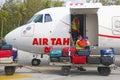 Man unloading baggages from Air Tahiti airplane