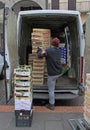 Man is unloading boxes with fruits in Padua, Italy