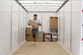 Man unloading portable storage unit