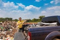 A man unloads his garbage from a pickup truck at a garbage dump in Paraguay. Royalty Free Stock Photo
