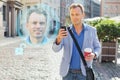 Man unlock his mobile phone with facial recognition and authentication technology