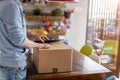 Man unpacking parcel ordered online at home Royalty Free Stock Photo