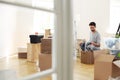 Man unpacking stuff from boxes while furnishing new flat after r Royalty Free Stock Photo