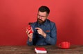 Man with unsatisfied face sits at wooden desk Royalty Free Stock Photo