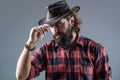 Man unshaven cowboys. American cowboy. Leather Cowboy Hat. Portrait of young man wearing cowboy hat. Cowboys in hat Royalty Free Stock Photo