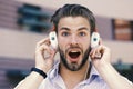 Man with unshaven face enjoy sound with modern headphones. Macho with surprised face likes music. Young man listening