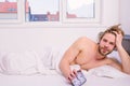 Man unshaven lay bed hold alarm clock. Man unshaven bearded wakeful face having rest. Stick schedule same bedtime wake Royalty Free Stock Photo