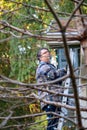 Man up on a ladder decorating his home for christmas