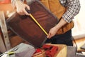 Man upholstering chair in his workshop