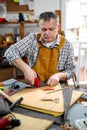 Man upholstering chair in his workshop Royalty Free Stock Photo