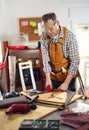 Man upholstering chair in his workshop