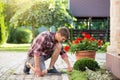 Man uproot weed from ground in garden Royalty Free Stock Photo
