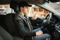 Man use disinfector in car. Handsome man protect himself and clean car inside using antiseptic