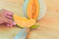 The man use knife split the orange melon