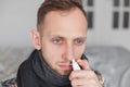 Man use nasal spray. concept of treatment for allergies or the common cold, winter style Royalty Free Stock Photo