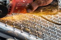 Man used angle grinder without cover guard cutting metal net